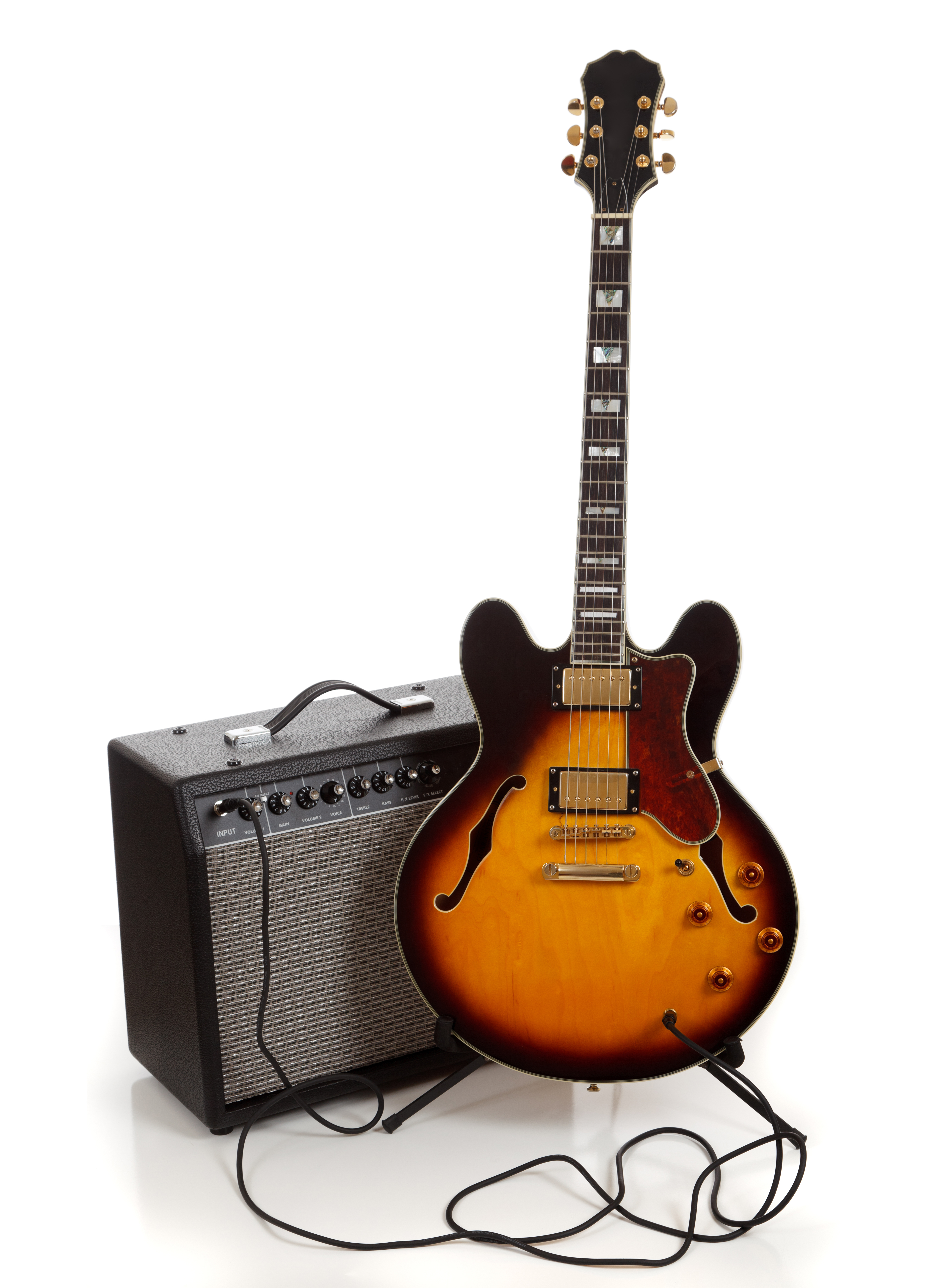 An electric guitar  and amplifier on a white background